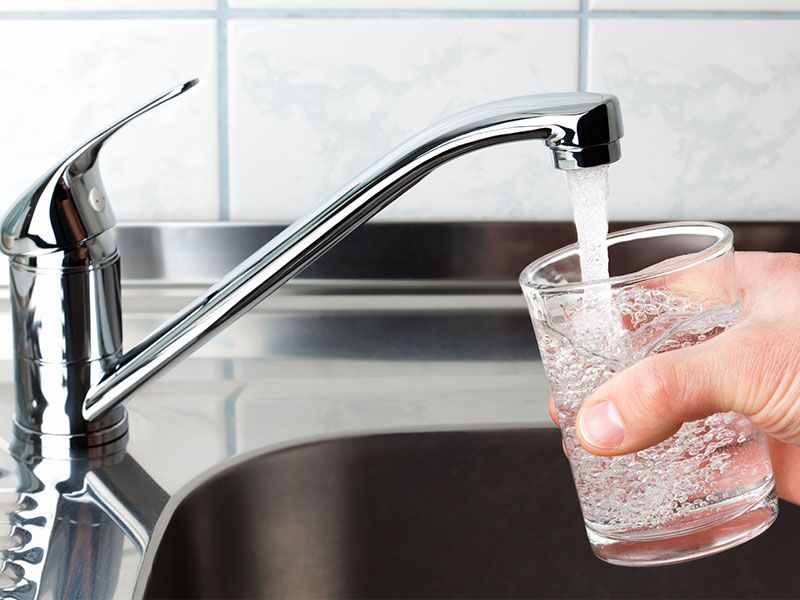 Glass being filled with clean tap water